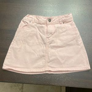 Pretty miniskirt in jean material.  Pink with adjustable waistband.